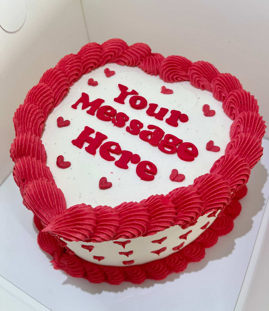Heart cake with mini love hearts and custom message Brisbane