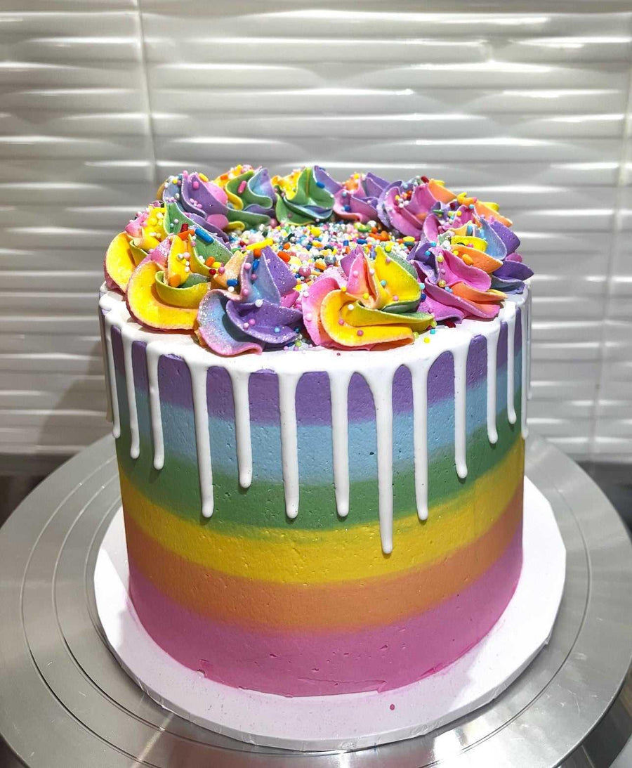Rainbow Cake Brisbane, Vibrant rainbow cake with colorful layers of buttercream icing, perfect for birthday celebrations, featuring a cheerful and bright design
