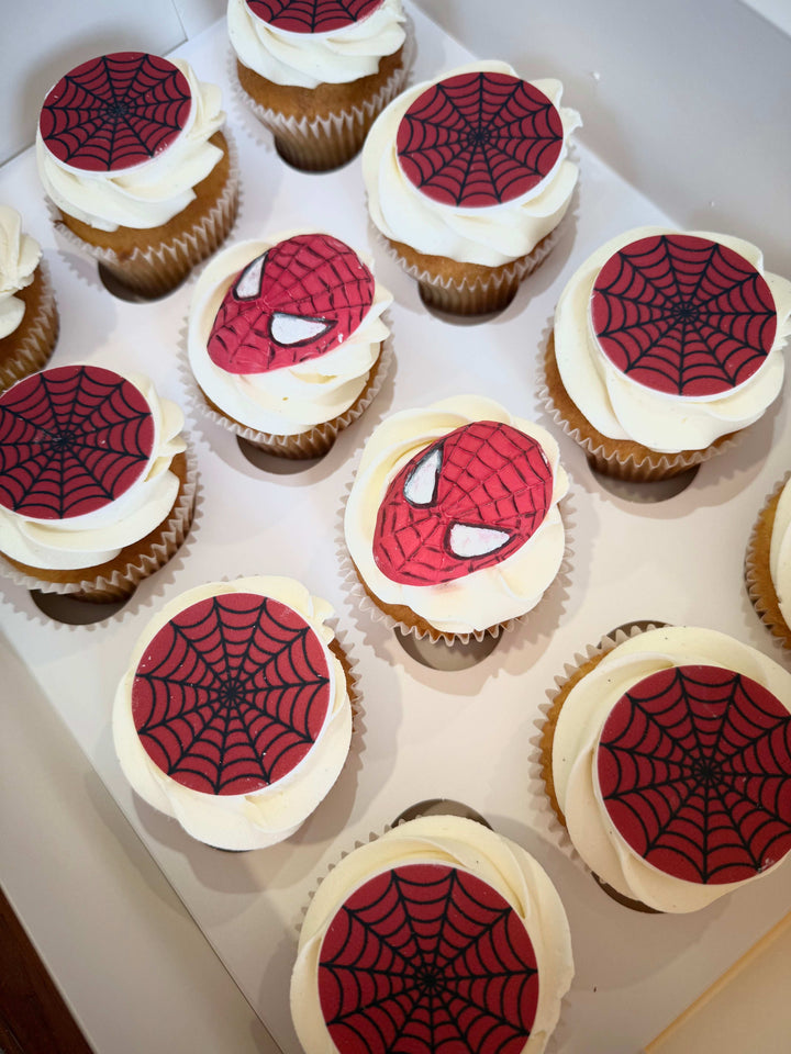 Cupcakes with Spider-Man designs on a white tray